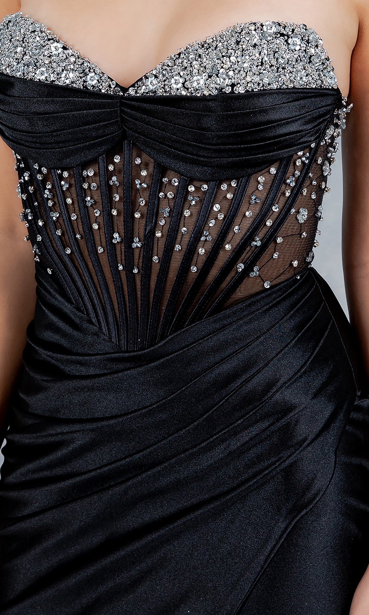 A close-up of the Cinderella Couture 8449J long prom dress showcases its strapless corset gown design with a sheer, vertically pleated bodice and silver rhinestone accents—ideal for formal occasions or prom.
